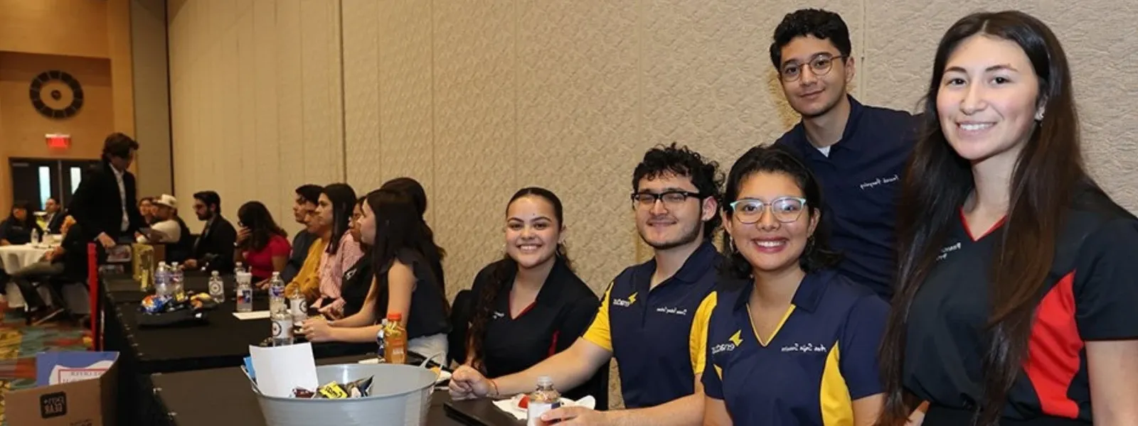 Members of ENACTUS and Financial Literacy Program smile at Vackar TalkX RGV Economic Outlook Symposium